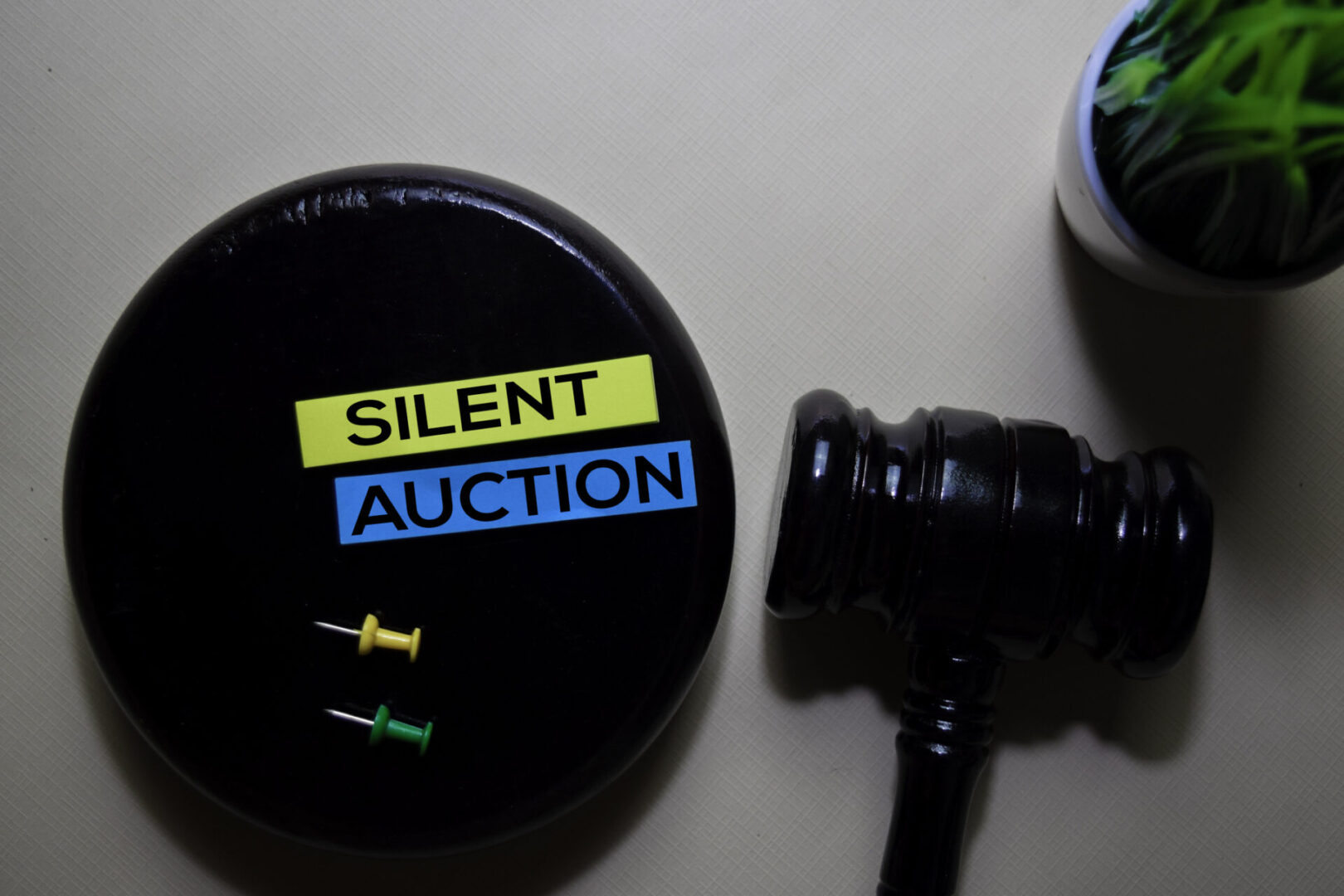 Silent Auction text on sticky notes and gavel isolated on office desk. Justice law concept